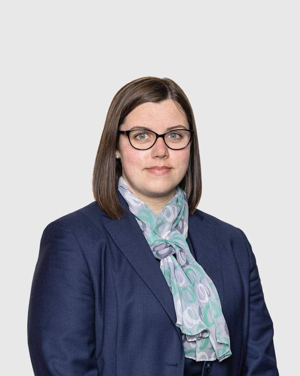 Professional woman in navy blazer and glasses